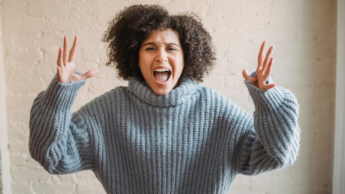Mother standing with arms raised, appearing frustrated and exasperated