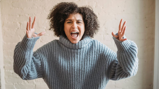 Mother standing with arms raised, appearing frustrated and exasperated